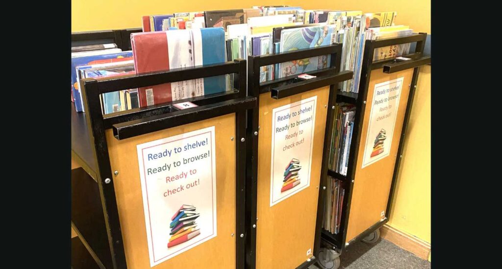 Image of library carts filled with books ready to be put back on the shelves.