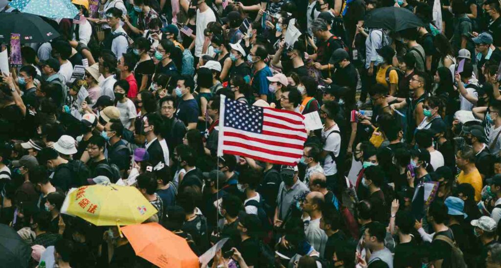 An image showing the American flag held up during a protest.