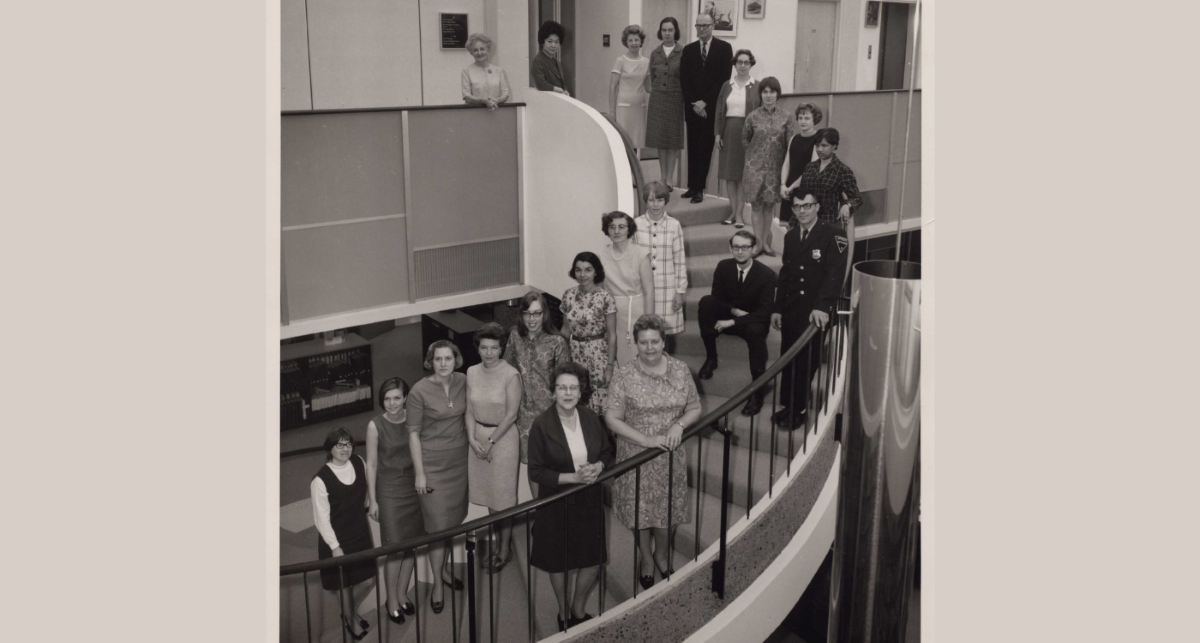 Librarians standing on stairs at old library building in 1968
