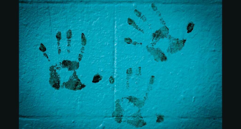Image of hand prints on a wall.