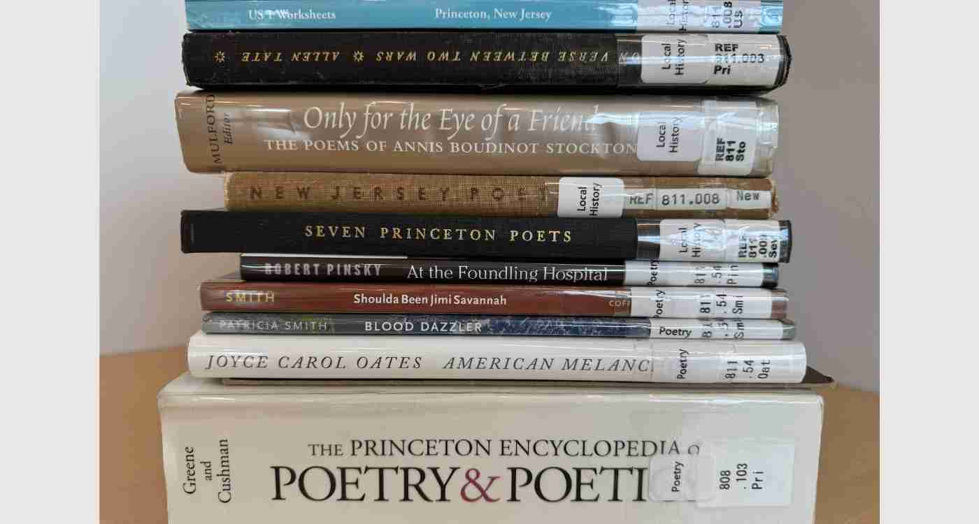 A stack of poetry titles from the collection, showing the title on the binding