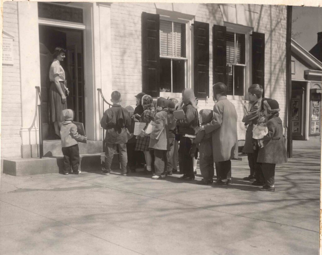 Children waiting in line to enter the library at Bainbridge House for Story Time in 1954.