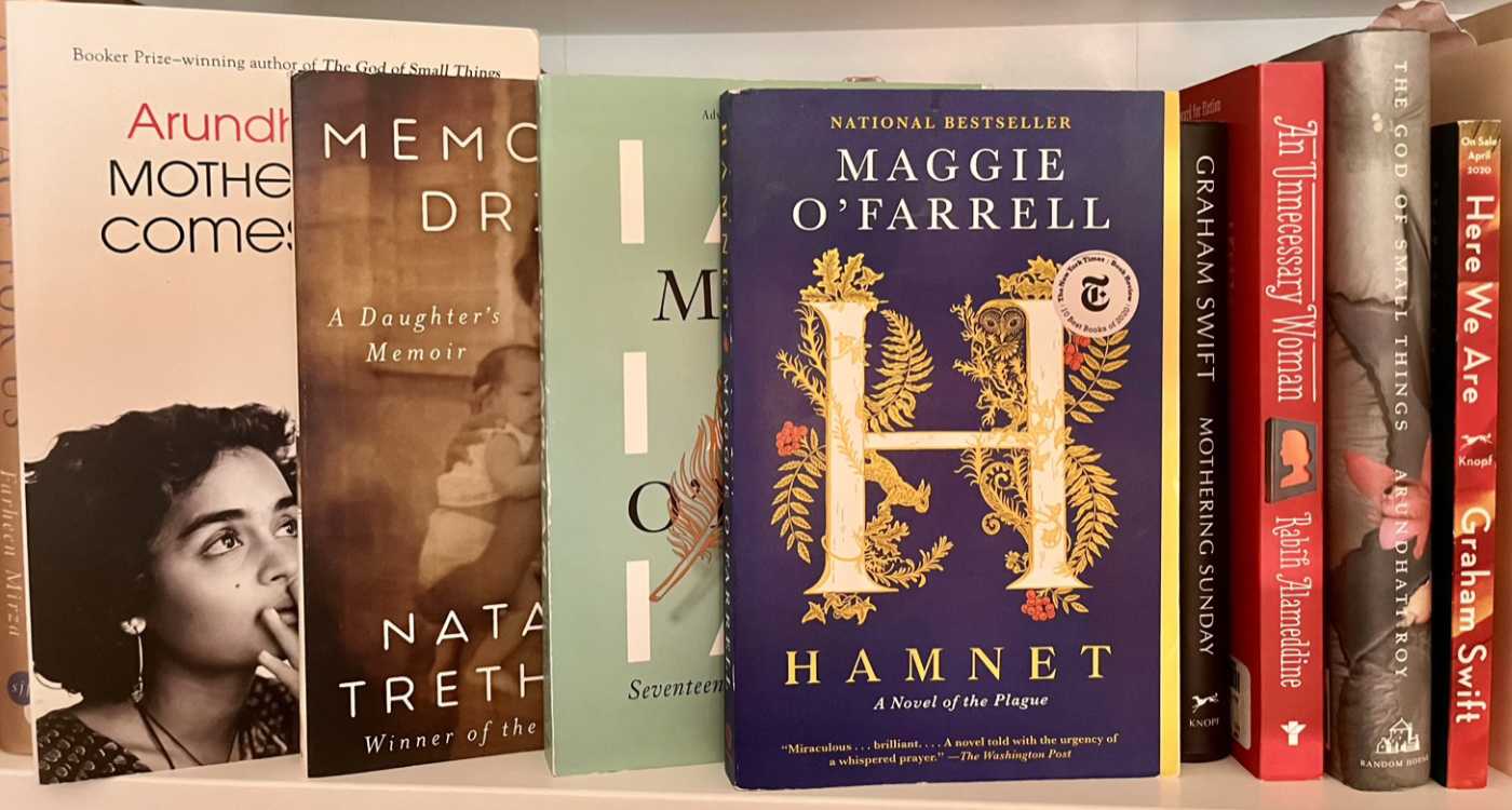 Book covers displayed on a shelf.